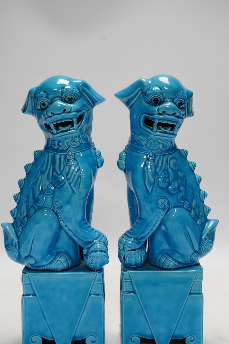 A pair of Chinese turquoise glazed lion dogs, 29cm. Condition - good